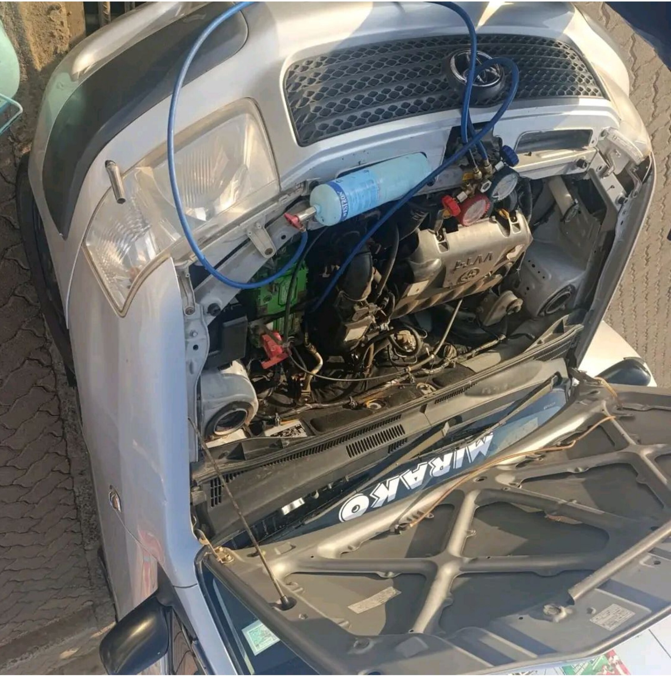 Car AC service — engine bay setup